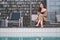 A beautiful asian woman enjoyed sitting by the swimming pool