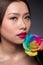 Beautiful asian woman face with perfect makeup with flowers of a