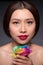 Beautiful asian woman face with perfect makeup with flowers of a