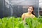 Beautiful Asian woman farming fresh organic vegetables.