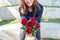 Beautiful asian woman giving red roses flower to her boyfriend on Valentine`s day with feeling happy and loved