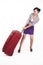 Beautiful Asian woman with heavy suitcase