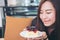 A beautiful asian woman holding blueberry cheese cake with feeling happy and good lifestyle