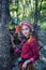 Beautiful Asian woman with karen traditional dress explore in forest during her summer vacation in thailand, Asia