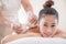 A beautiful Asian woman is laid back and relaxing, the masseuse uses a hot herbal compress in a spa shop