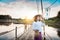 Beautiful Asian woman in local dress holding fishing trap standing and enjoy on bamboo bridge in rice field with decoration on pa