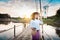 Beautiful Asian woman in local dress holding fishing trap standing and enjoy on bamboo bridge in rice field with decoration on pa