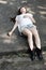 Beautiful Asian woman lying on cement floor