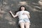 Beautiful Asian woman lying on cement floor