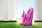 Beautiful asian woman in pink veil sitting in praying position and raise the hands on the carpet inside the room