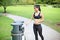 Beautiful asian woman recycling in park after her run