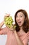 Beautiful asian woman shocked expression while holding grape