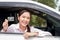 Beautiful Asian woman sitting in a car, happy smile Hold a credit card to pay for car repairs.