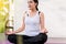 Beautiful asian woman sitting practicing doing yoga meditating after waking up at home,Healthy and lifestyle concept