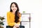 Beautiful asian woman smile and wearing yellow shirt and standing in workplace room at house