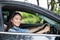 Beautiful Asian woman smiling and enjoying.driving a car on road