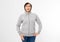 Beautiful asian woman in a sweatshirt and hood posing on white background - mock up