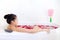 Beautiful asian woman takes a bath in jacuzzi with rose petals