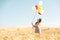 Beautiful asian woman in a wheat field with air balloons