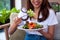 Beautiful Asian women are enjoying eating salad with salmon to lose weight. Healthy young woman eating vegetable salad. Dieting ,