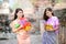 Beautiful Asian women hold plastic water guns at an ancient temple during Songkran, the most beautiful and fun water festival in