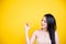 Beautiful Asian women smile happyness holding fresh orange slide with a yellow background.Squeeze Fresh oranges healthy fruits tha