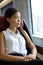 Beautiful Asian young professional woman enjoying view on travel commute. Business class by train. Businesswoman