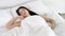 Beautiful asian young woman sleeping lying in bed with head on pillow comfortable and happy moving panning camera. girl with relax