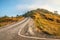 Beautiful asphalt country road side on the green mountain background in morning sunlight, Phetchabun Thailand. Road trip, travel