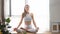 Beautiful athlete woman in training clothes doing fitness exercise in yoga studio