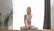 Beautiful athlete woman in training clothes doing fitness exercise in yoga studio