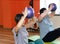 Beautiful athletic Caucasian young female trainer in the gym doing fitness with people. The concept of sports, fitness, weight