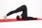 Beautiful athletic girl in black suit doing yoga. halasana asana - plow pose. Isolated on white background.