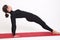 Beautiful athletic girl in a black suit doing yoga. Purvottanasana asana plank pose. on white background.