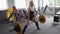 A beautiful athletic girl is engaged in the gym. Barbell, deadlift