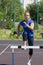 A beautiful and athletic girl is running hurdles in the stadium