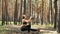 Beautiful, athletic, sexy young woman, coach, instructor, performs exercises, doing exercises. In pine forest, in summer