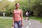 Beautiful athletic woman standing running track in summer park Portrait caucasian female jogger outdoor