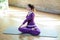 Beautiful athletic young female make yoga, Lotus position Padmasana Twisting.