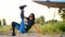 Beautiful, athletic, young woman in sunglasses, in tights, performs different strength exercises, jumps, push-ups