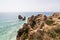 Beautiful atlantic ocean view horizon with sandy beach rocks with stairs on beach on Atlantic ocean in Portugal