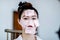 Beautiful Attractive Asian woman using Facial oil clean film to removal oily on face