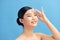 Beautiful Attractive Asian woman using Facial oil clean film to removal oily on face for face fresh skin feeling so fresh and