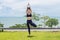 Beautiful Attractive Asian young woman practice Tree Pose stretching exercises muscle for warm up