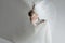 Beautiful attractive bride in wedding dress with long full skirt, white background, dance and smile, top view