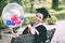 Beautiful Attractive Graduate celebrating with balloon and certificate
