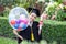 Beautiful Attractive Graduate celebrating with balloon and certificate in her hand