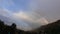 beautiful attractive seven colours rainbow in between mountains in india.