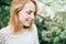 Beautiful attractive young woman posing in spring syringa park w