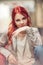 Beautiful, attractive young woman with red hair relaxing in town, shopping